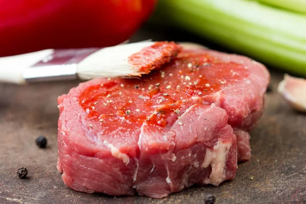 Bife cru, escova de molho de tomate untada, cozinhando delicioso di — Fotografia de Stock