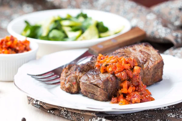 Grilled beef steak with salsa sauce dried tomatoes, red peppers — Stock Photo, Image