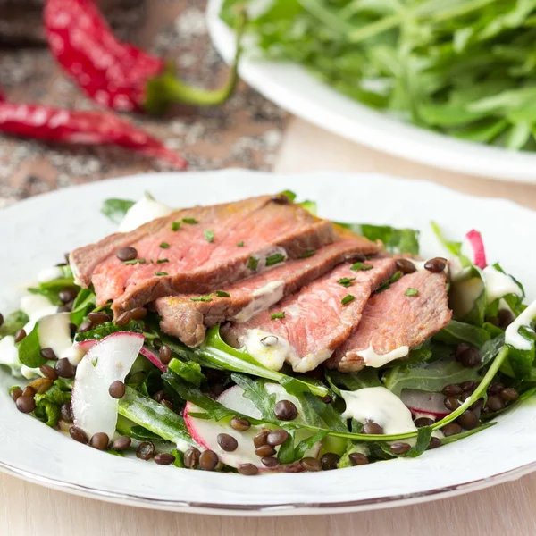 Salade met gegrilde biefstuk, zwarte linzen, raket, radijs, cu — Stockfoto