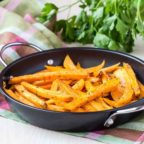 Sweet potatoes, batata, sliced, fried in pan with spices, herb — Stock Photo, Image