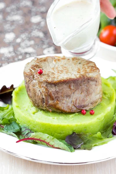 Grilled beef steak, green mashed potatoes with peas, herbs, tast — Stock Photo, Image