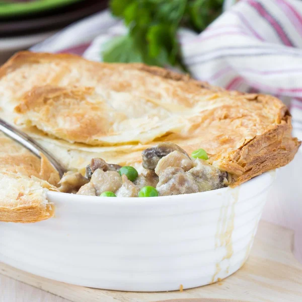Meat pie with stew of chicken, mushrooms, peas, puff pastry — Stock Image Meat pie with stew of chicken, mushrooms, peas, puff pastry Royalty Free Stock Photos