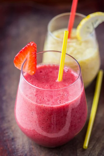 Sweet strawberry and lemon smoothie in the glass, wooden vintage — Stock Photo, Image