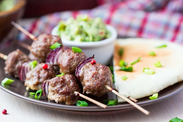 Kebab de carne, bolas de ternera en pincho con cebolla, salsa guacamole —  Fotos de Stock
