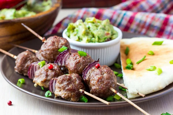 Kebab de carne, bolas de ternera en pincho con cebolla, salsa guacamole —  Fotos de Stock