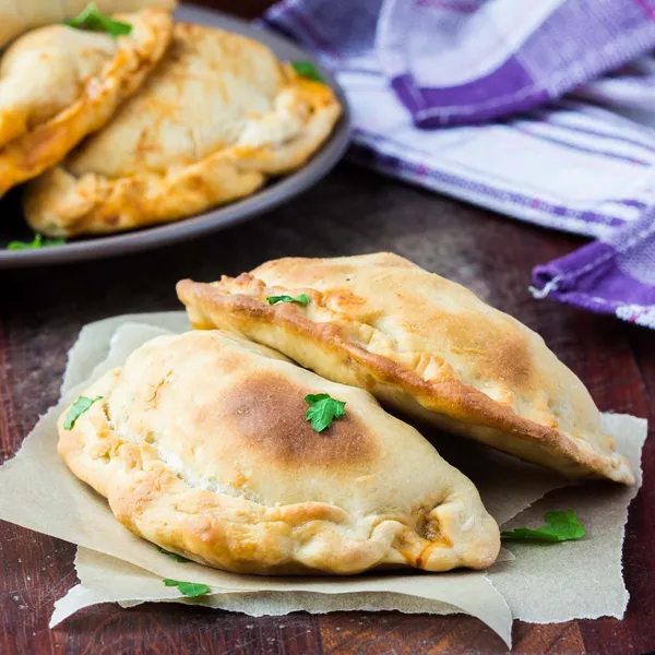 Mini calzone, closed pizza, Italian pastry stuffed with cheese — Stock Photo, Image