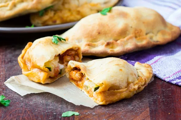 Mini calzone, pizza cerrada, pastelería italiana rellena de queso —  Fotos de Stock