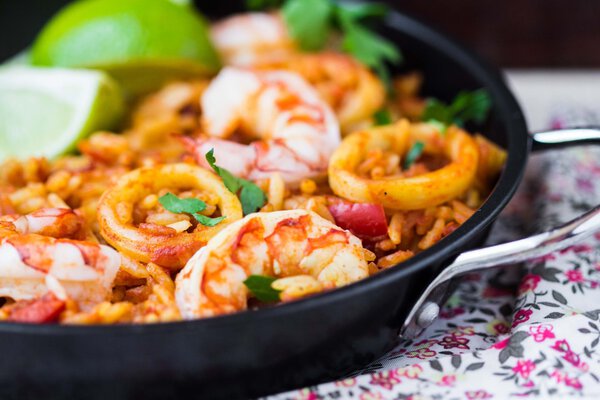 Spanish dish paella with seafood, shrimps, squid, rice, saffron