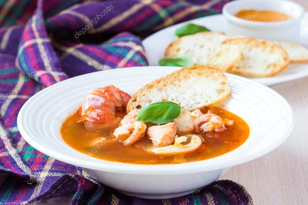 French Bouillabaisse fish soup with seafood, salmon, shrimp, ric