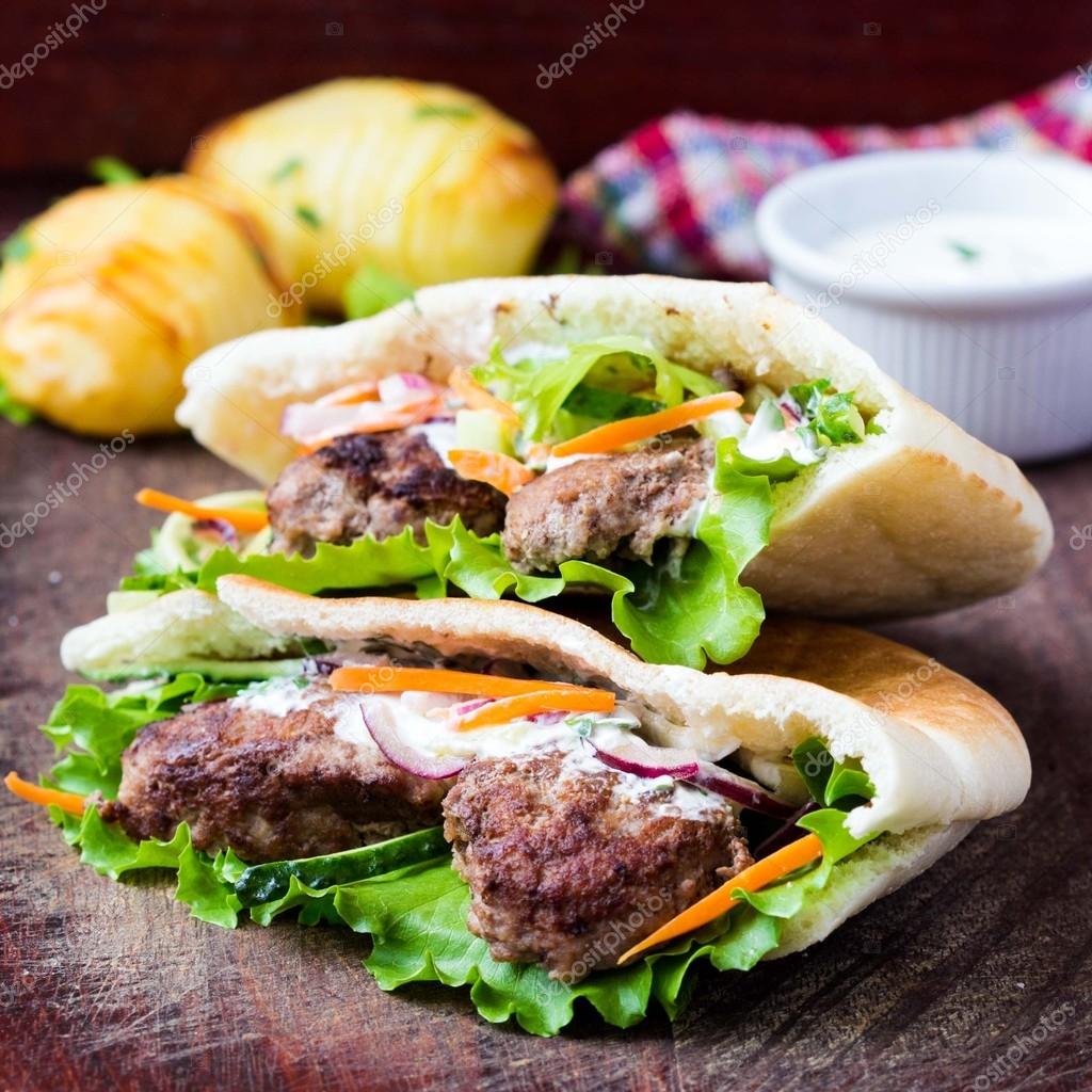 Minced meat kebab, beef balls in flat cake with vegetable Stock Photo