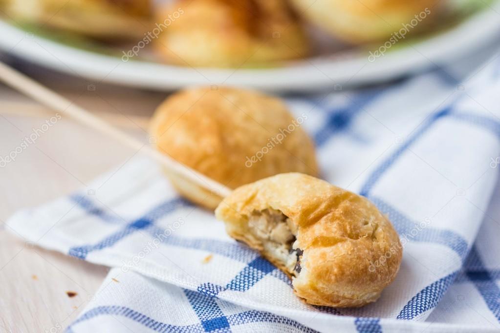 Puff pastry pies with meat filling of chicken on sticks for chil