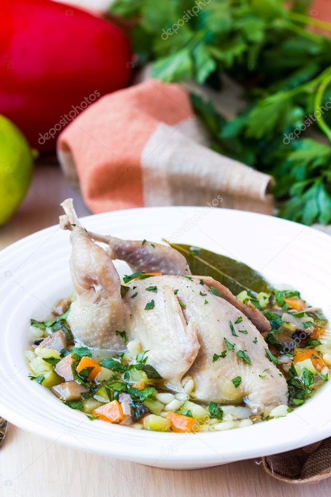 Summer soup with quail, vegetables, pearl barley, herbs, tasty m
