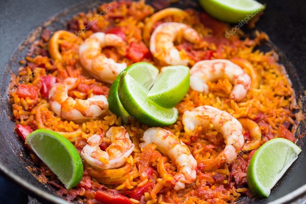 Spanish dish paella with seafood, shrimps, squid, rice, saffron — Stock