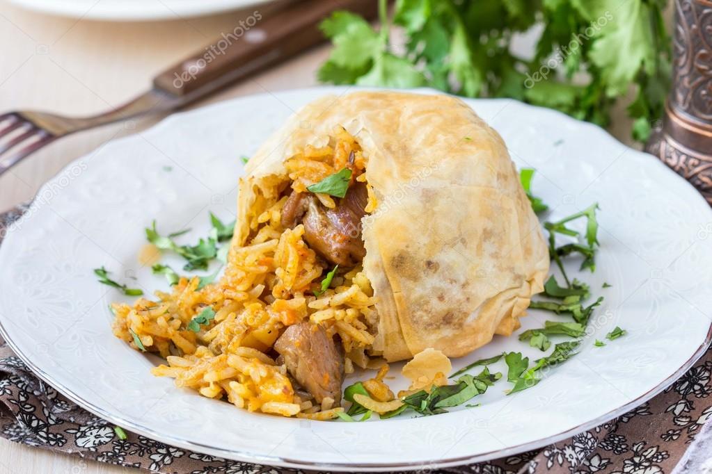 Oriental shah pilaf, pilaw, plov, rice with meat in filo