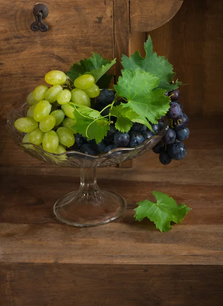 Grapes in glass vase — Stock Photo, Image
