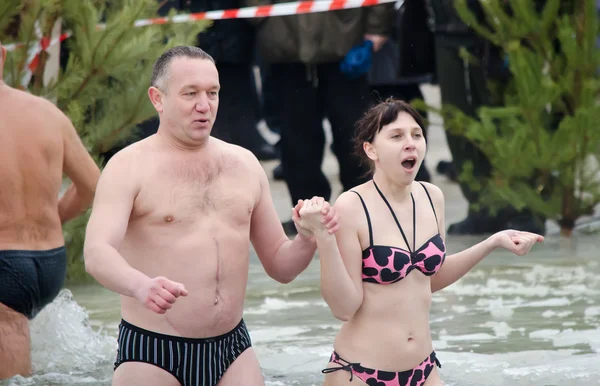 Mensen Baden in de rivier in de winter. christelijke religieuze festival epiphany — Stockfoto