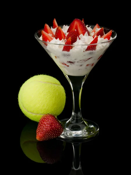 Strawberry with cream and a tennis ball. — Stock Photo, Image