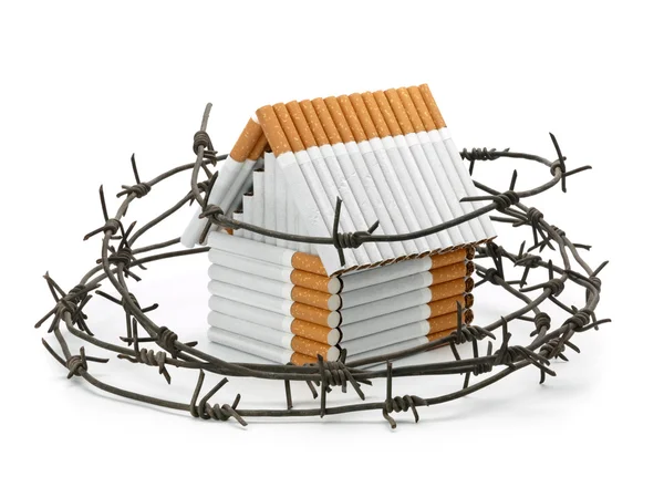 The house from cigarettes behind a barbed wire — Stock Photo, Image