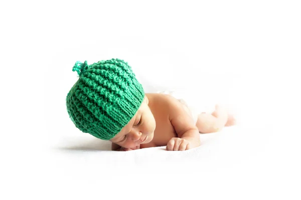 Newborn baby in a green cap — Stock Photo, Image