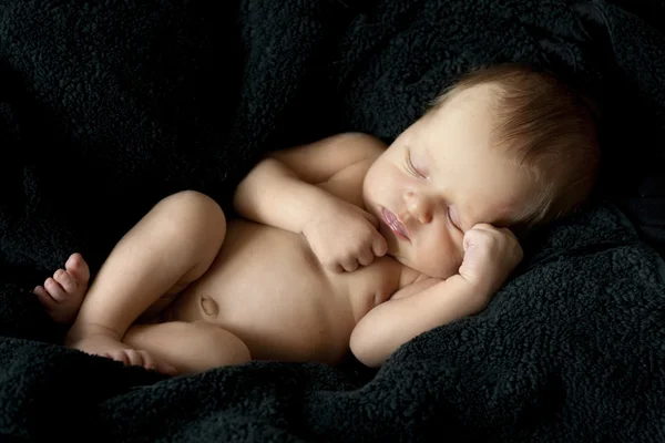 Newborn nice baby on a black background — Stock Photo, Image