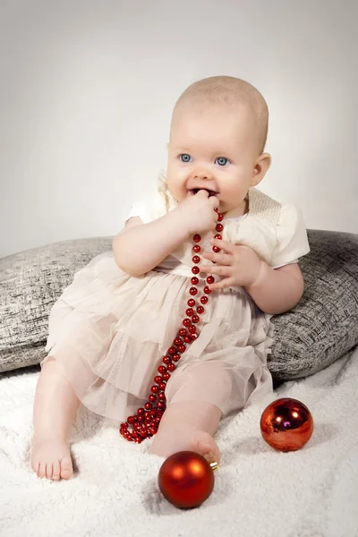 Baby girl with beads — Stock Photo, Image