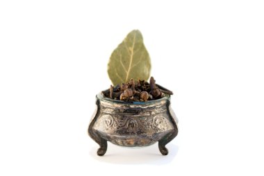 Cloves and bay laurel in the salt cellar is glass clipart