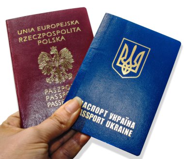 Two passports of Ukraine and Poland in the hand clipart