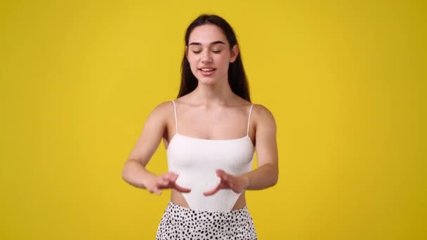 Video Smiling Woman Making Heart Her Hands Yellow Background Concept — Stock Video