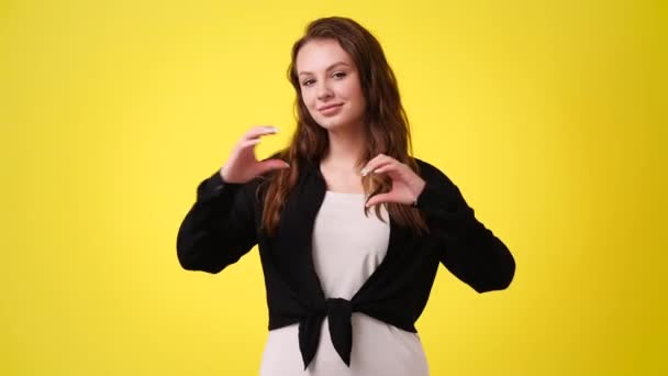 Video Smiling Woman Making Heart Her Hands Yellow Background Concept — Stock Video