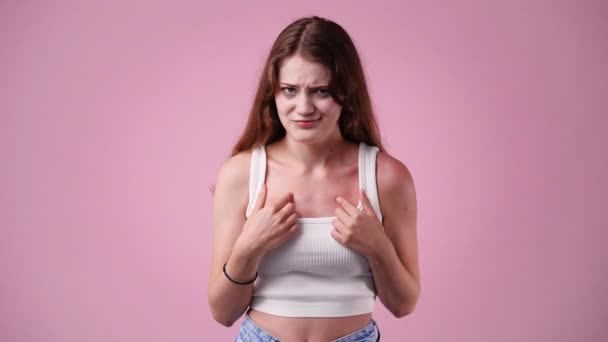 Video Girl Who Puts Her Hands Her Chest Pink Background — Stock Video
