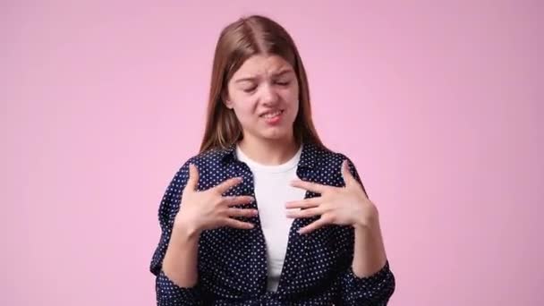 Video Girl Who Puts Her Hands Her Chest Pink Background — Stock Video