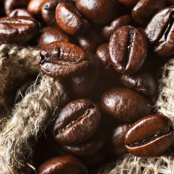 Coffee beans in a bag on sacking. — Stock Photo, Image