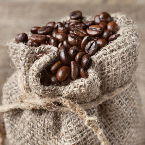 Coffee beans in burlap bag — Stock Photo, Image