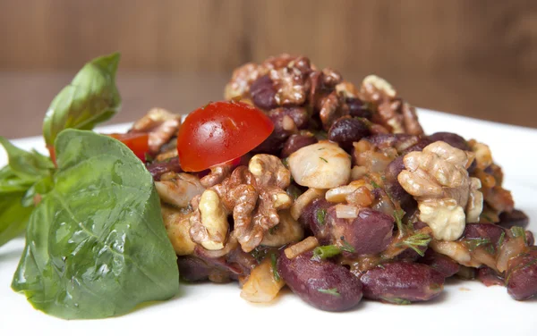 Salad with walnuts and beans on a plate — Stock Photo, Image