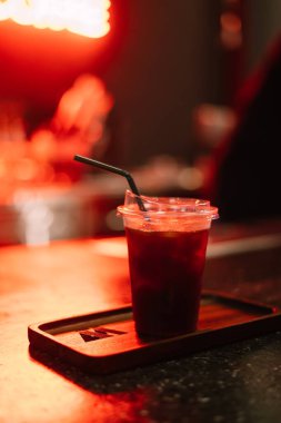 Neon ışıklarıyla kahve dükkanındaki masada buzlu kahve.