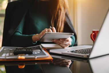 İş adamı dijital tablet bilgisayar ve akıllı telefon ile çalışıyor. Finansal iş stratejisi katmanı etkisi sabah güneşinde masada.