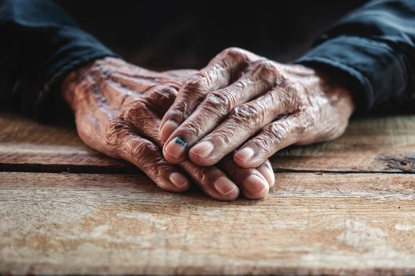 Close up of male wrinkled hands, old man is wearing wintage ton