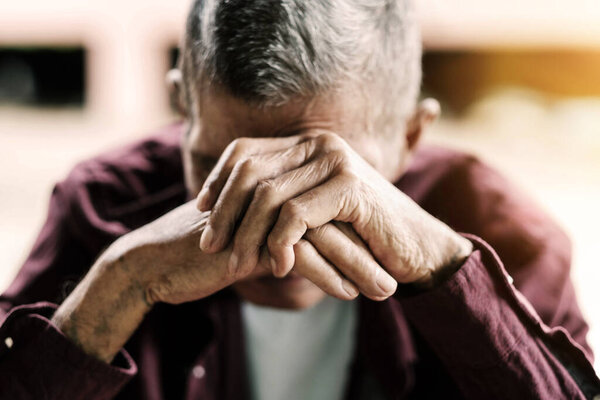 senior man covering his face with his hands. Depression and anxiety Copy space