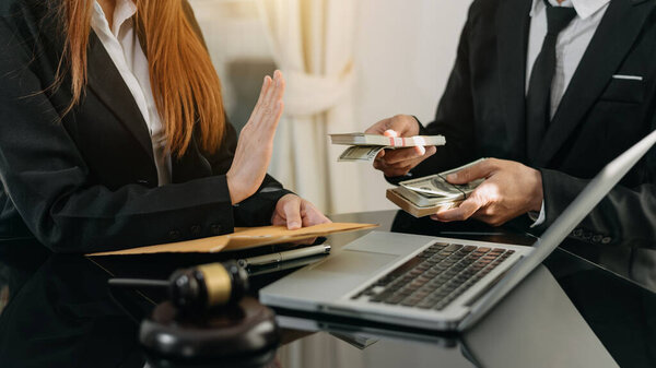 Lawyer refusing bribe money in the envelop from business man at the lawyer office
