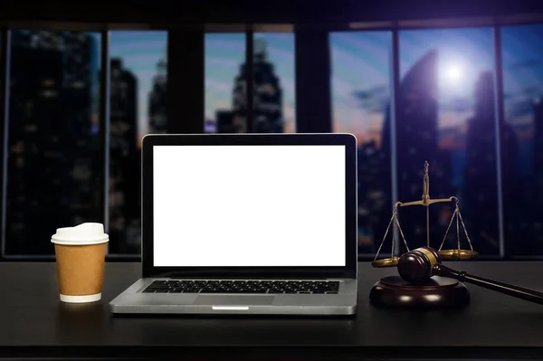 ノートパソコンの白い画面と法律木製のギャベルと裁判官の真鍮スケールと弁護士のワークスペース 法廷の概念 — ストック写真