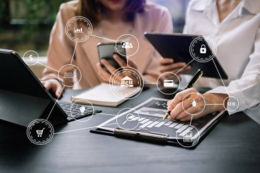 brainstorming team using laptop and smart phone at office 