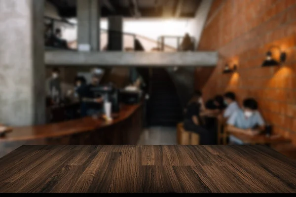wooden table at restaurant, blurry background with people customers