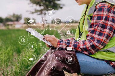 Agriculture technology farmer woman holding tablet or tablet technology to research about agriculture problems analysis data and visual icons