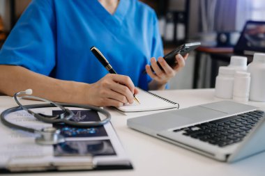 Healthcare business graph and Medical examination and businessman analyzing data and growth chart on smartphone laptop background 