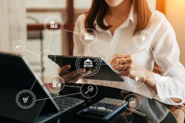 Businesswoman working virtual tablet computer with reduce CO2 concept with icons, global warming such as reforest green factory recycle and zero carbon dioxide emission concept. and green business concept 