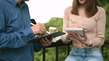 two colleagues discussing data while working together