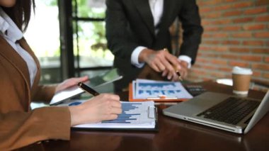 business team working with documents and gadgets in office 