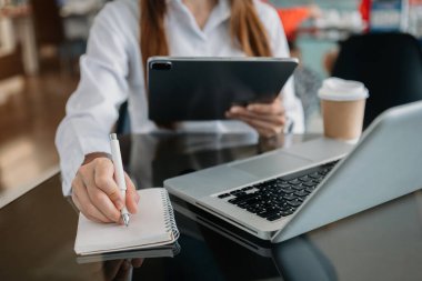 young professional businessman writing in notebook