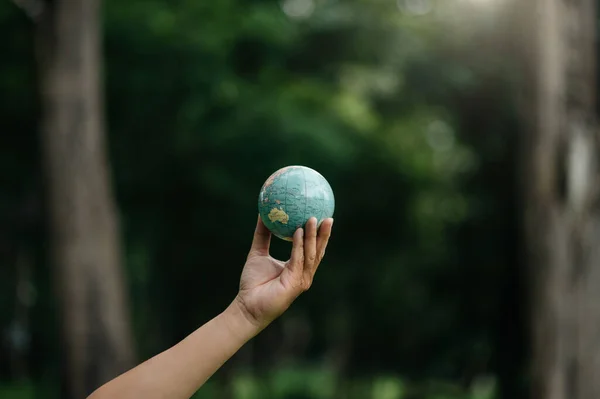 Green planet, globe in woman hand. Save Earth. environmental and Energy saving concept