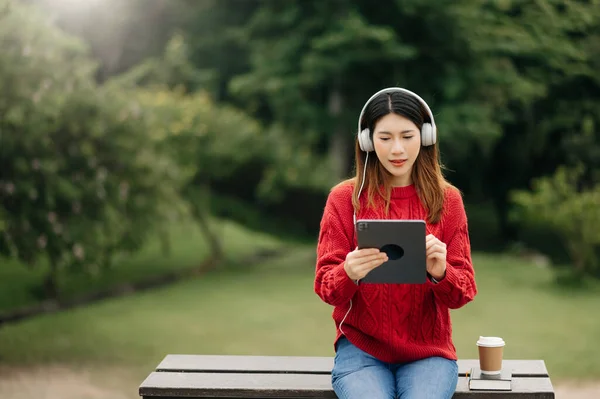 Hermosa Joven Asiática Mujer Escuchando Música Con Auriculares Sentado Banco — Foto de Stock